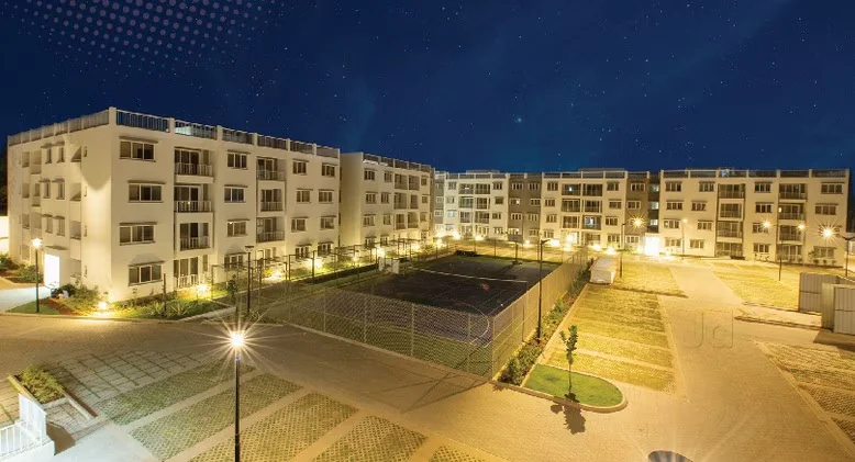 Exterior view of Godrej Eternity residential project in South Bangalore featuring low-rise blocks, sprawling courtyards, and lush green landscaping.